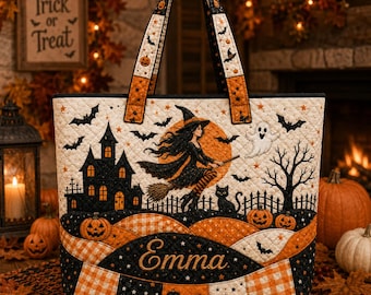 May include: A quilted tote bag featuring a Halloween theme with a witch on a broomstick, a haunted house, a ghost, and a black cat. The bag has an orange and black color palette with a checkered pattern and the name Emma embroidered in gold.