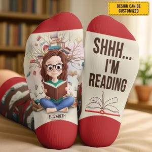 May include: A pair of socks with a red toe and cuff. One sock features a cartoon girl reading with the name "Elizabeth" below. The other sock says "SHHH... I'M READING" with an open book graphic. The design can be customized.
