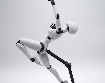 Könnte beinhalten: Eine weiße, bewegliche Figur mit schwarzen Gelenken und einem schwarzen Ständer, in einer dynamischen Pose. Die Figur hat eine gesprenkelte Textur und ist mit einem erhobenen Arm und dem anderen Bein ausgestreckt positioniert, was Bewegung suggeriert.