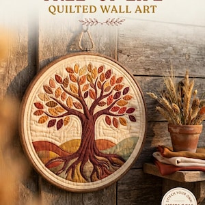 May include: A circular quilted wall art piece featuring a tree of life design with a dark brown trunk and roots, surrounded by autumn-coloured leaves in shades of red, orange, and yellow. The text reads TREE OF LIFE QUILTED WALL ART and STITCH YOUR OWN HEIRLOOM TREASURE.