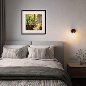 May include: A framed print of a cozy reading nook with a window view. The artwork depicts a room with a bookshelf, armchair, and a window overlooking a lush green tree. The frame is black, and the scene is illuminated by natural light.