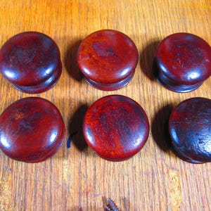 May include: A rustic wooden sign with the text "Welcome to our home" in a handwritten style. The sign features a distressed finish and a simple, inviting design, perfect for a front porch or entryway.