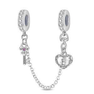 May include: A silver charm bracelet safety chain with two ends. One end features a key charm with a pink gem, and the other a heart-shaped charm with a keyhole design. Both ends have a ring of clear stones.