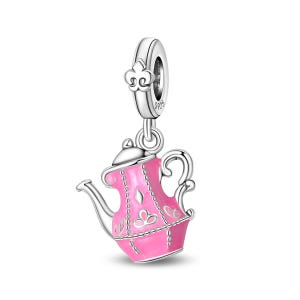 May include: A silver charm with a pink teapot design. The teapot has a silver handle, spout, and lid. The pink body of the teapot is decorated with white floral and diamond patterns. The charm is suspended from a silver ring with a fleur-de-lis design.