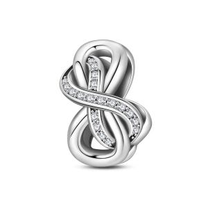May include: A silver-colored charm in the shape of an infinity symbol. The charm is adorned with small, clear gemstones that are set along the curves of the design. The piece has a polished, reflective surface and is set against a white background.
