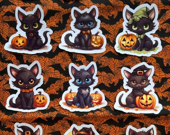 May include: A collection of Halloween-themed stickers featuring cartoon black cats with jack-o'-lanterns. The cats wear witch hats, bow ties, and collars. The background is orange with a spiderweb and bat pattern.