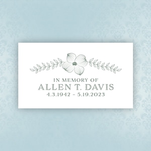 May include: A white card with a black border and a floral design. The text reads "In Memory of Allen T. Davis 4.3.1942 - 5.19.2023".