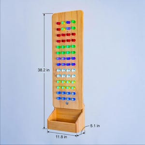 May include: A vertical wooden pegboard with a storage bin at the base, featuring rows of colorful pegs in red, green, blue, and white. The board measures 38.2 inches in height, 11.8 inches in width, and 5.1 inches in depth as indicated by labels.