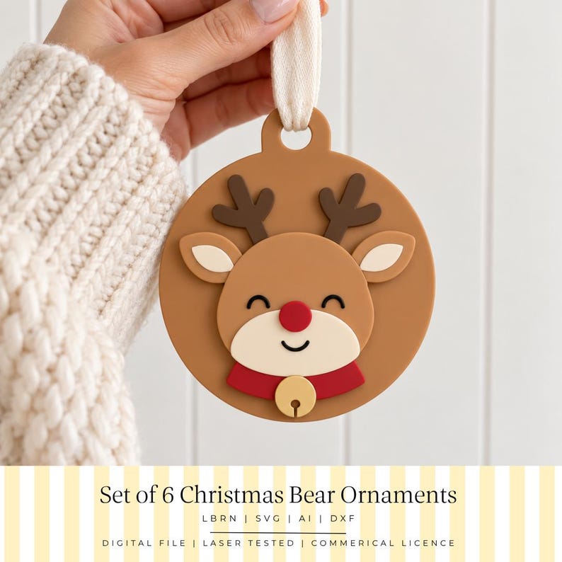May include: A circular tan ornament featuring a raised reindeer design with dark brown antlers, a red nose, and a red collar with a gold bell. The ornament has a cream-colored fabric loop at the top for hanging. Text below reads Set of 6 Christmas Bear Ornaments.