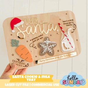 May include: Wooden Santa cookie and milk tray with laser-cut details. Features a red Santa hat, carrot, gingerbread cookie, and a milk glass with a straw. Includes the text "Dear Santa" and "Merry Christmas from the Hack Family."