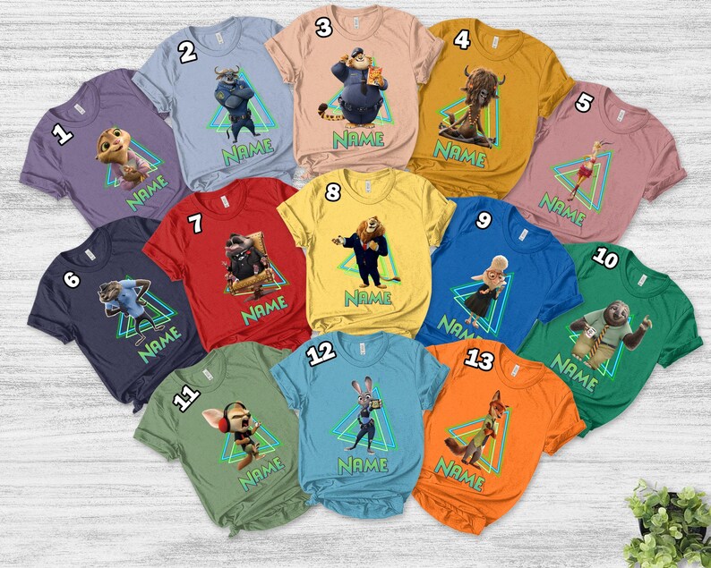 May include: A selection of short-sleeved t-shirts in various colours, each featuring a character from a movie. Each shirt has a character image inside a green and blue triangle, with the word "NAME" below the image.