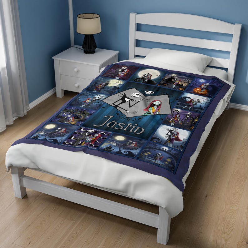 May include: A dark blue fleece blanket featuring a collage of scenes from The Nightmare Before Christmas, with the name Justin printed in white script across the center. The design includes various characters and moonlit settings in shades of blue.