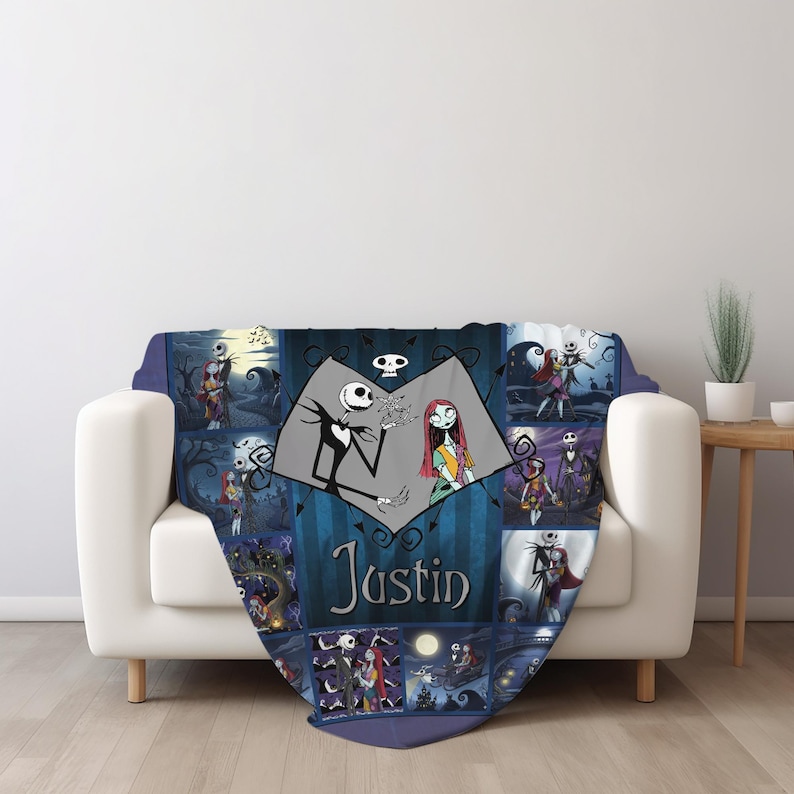 May include: A blue and black patterned throw blanket featuring a collage of scenes with Jack Skellington and Sally from The Nightmare Before Christmas. The center displays a heart-shaped graphic with the characters and the name Justin printed below.