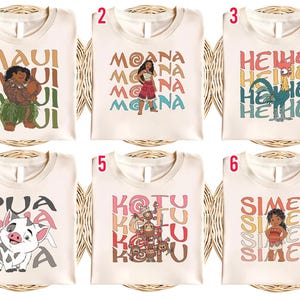 May include: Six cream-colored t-shirts with different designs. Each shirt features a character from the animated film "Moana" along with the character's name. The designs include Maui, Moana, Hei Hei, Pua, Kakamora, and Sina.