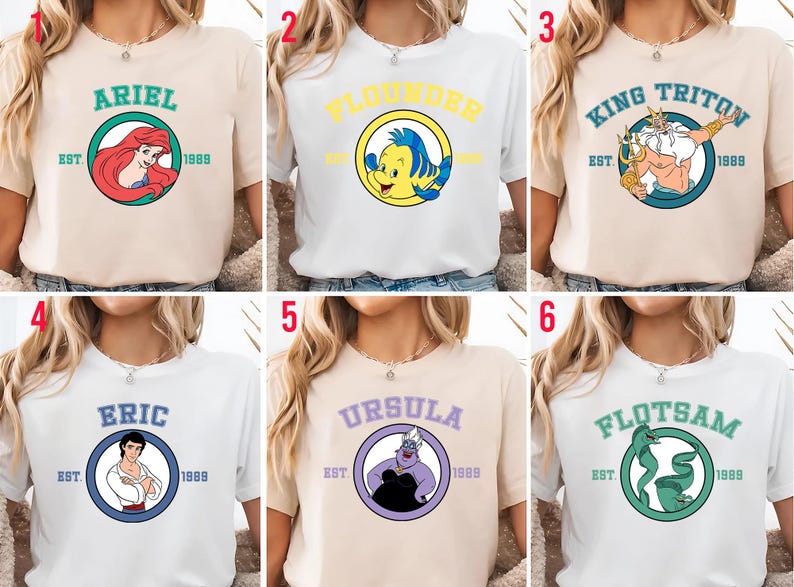 Puede incluir: Seis camisetas con personajes de una popular pel&iacute;cula animada. Cada camiseta muestra el nombre de un personaje en un c&iacute;rculo con el a&ntilde;o "1989" y "EST." Los personajes incluyen a Ariel, Flounder, Rey Trit&oacute;n, Eric, &Uacute;rsula y Flotsam.