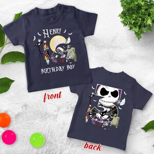 May include: Navy blue t-shirts with a graphic design featuring characters from "The Nightmare Before Christmas." The front of the shirt says "Henry Birthday Boy." The back of the shirt has a large number 5 with Jack Skellington's face.