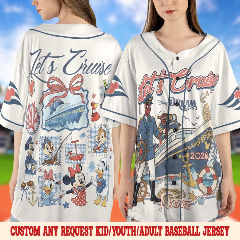 May include: White baseball jersey with a navy blue collar and button closure. The jersey features a cruise ship design with the text "Let's Cruise" and various Disney characters. The text "DREAM 2026" is also visible.
