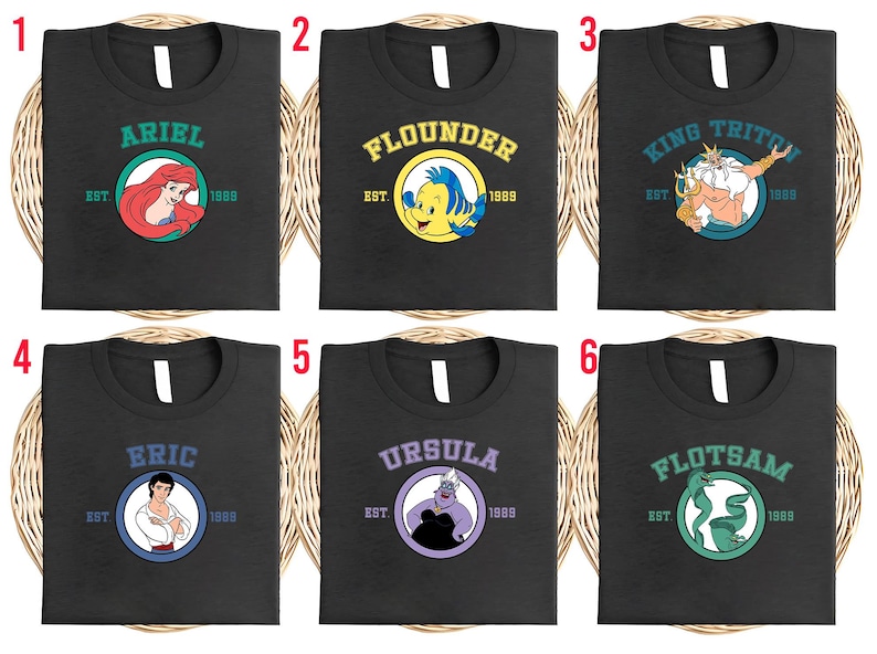 Puede incluir: Seis camisetas negras con diferentes dise&ntilde;os de personajes de La Sirenita. Cada camiseta presenta un nombre de personaje, un gr&aacute;fico y el a&ntilde;o "1989". Los personajes incluyen Ariel, Flounder, Rey Trit&oacute;n, Eric, &Uacute;rsula y Flotsam.