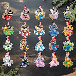 May include: A collection of 20 colorful cartoon character stickers, each depicted relaxing in a pool float and holding an ice cream cone. Characters include Mickey Mouse, Minnie Mouse, Donald Duck, and others. The stickers are on a dark wood background.