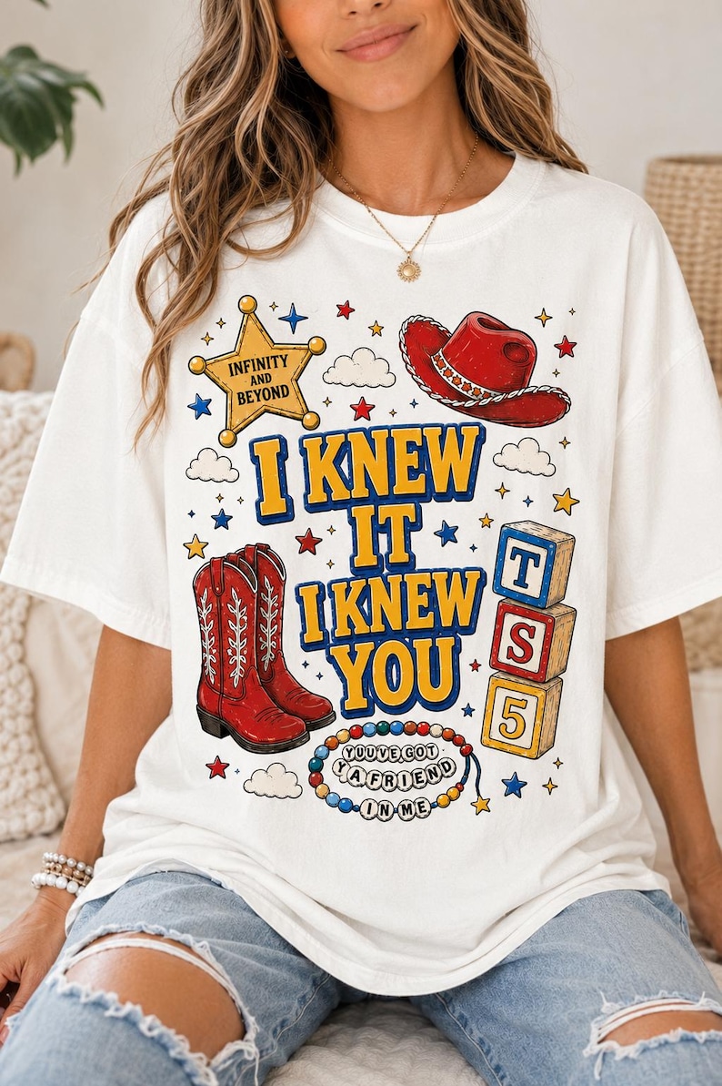 May include: A white t-shirt featuring a graphic print with a yellow sheriff star labeled INFINITY AND BEYOND, a red cowboy hat, red cowboy boots, a stack of blocks labeled T, S, 5, and a beaded necklace with the text YOU'VE GOT A FRIEND IN ME.