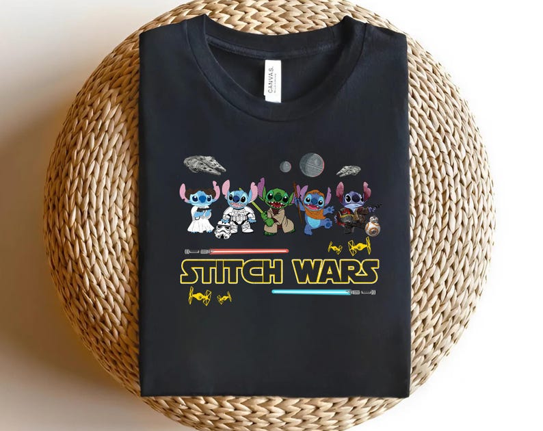 May include: Black t-shirt featuring a graphic of several Stitch characters in various costumes, with the text "Stitch Wars" in yellow and red. The design includes lightsabers and space-themed elements.