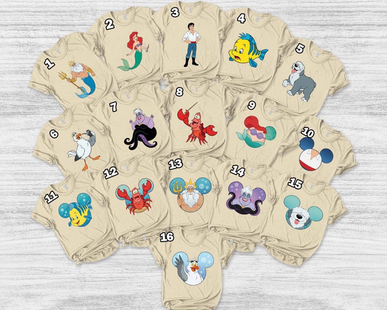 May include: A collection of beige t-shirts featuring various cartoon characters from a popular animated film. Designs include a mermaid, a crab, a fish, and other characters. The shirts are arranged in a circular pattern.