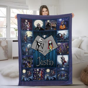 May include: A rectangular fleece blanket featuring a collage of scenes from The Nightmare Before Christmas. The center displays a heart-shaped graphic with Jack Skellington and Sally, along with the name Justin printed in a dark blue font.