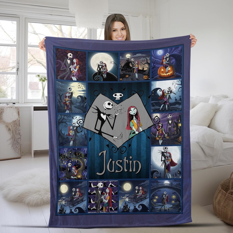 May include: A rectangular fleece blanket featuring a collage of scenes from The Nightmare Before Christmas. The center displays a heart-shaped graphic with Jack Skellington and Sally, along with the name Justin printed in a dark blue font.