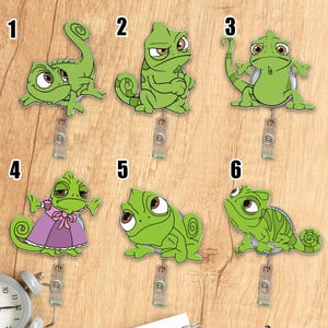 May include: A collection of six green chameleon badge reels with different poses and expressions. Each reel has a clear plastic clip and a retractable cord. One chameleon wears a purple dress.