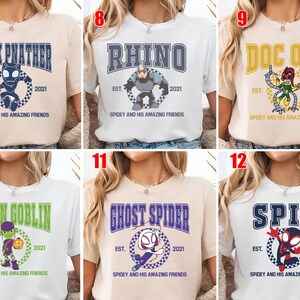 May include: Collection of t-shirts featuring various characters from a comic book series. Each shirt displays a character's name in bold letters, along with an image of the character and the text "Spidey and His Amazing Friends".