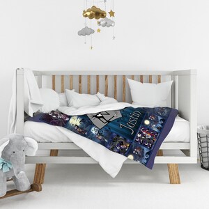 May include: A soft blanket featuring a collage of scenes from The Nightmare Before Christmas, including characters Jack Skellington and Sally, with the name Justin printed in a stylized font against a dark blue and purple background.