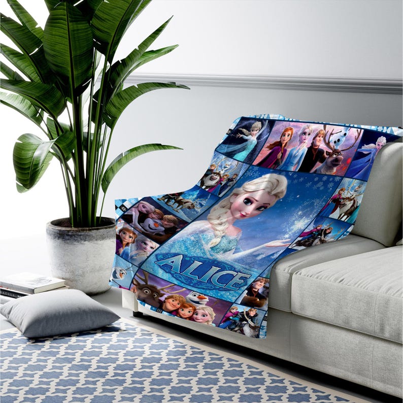 May include: A soft throw blanket featuring a collage of characters from the movie Frozen, including Elsa, Anna, Kristoff, Sven, and Olaf. The design includes a large central image of Elsa and the name Alice printed in a bold, icy blue font.