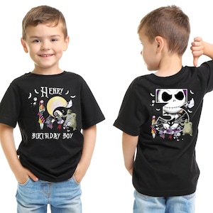 May include: Black t-shirt featuring a cartoon design with the text "Henry Birthday Boy". The front design includes characters, a moon, and the text. The back design features a skull and the number 5.