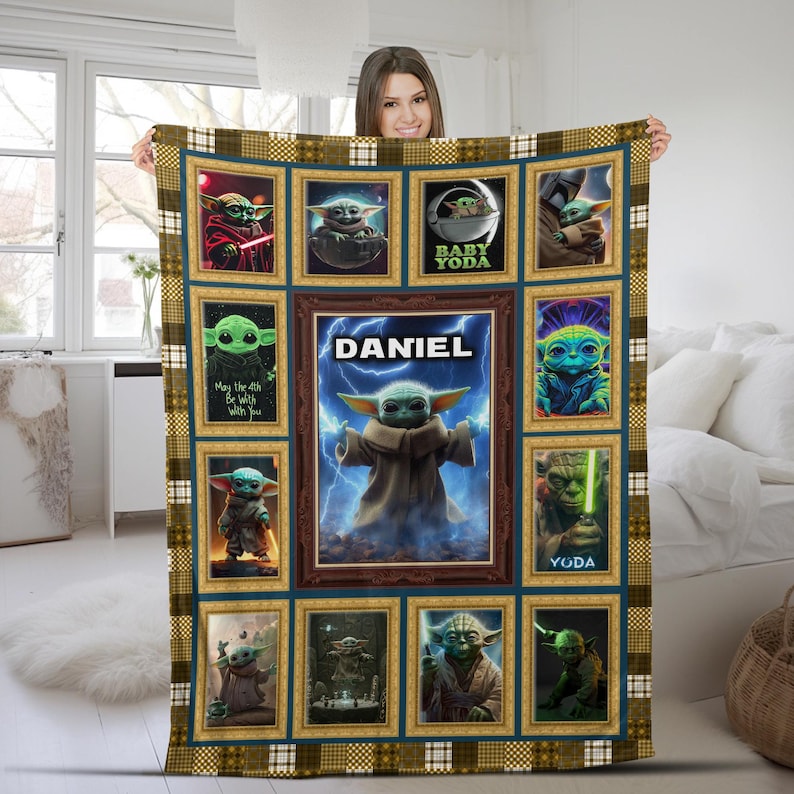 May include: A rectangular fleece blanket featuring a collage of Star Wars character images in gold-toned frames. The center panel displays a green creature with large ears surrounded by blue lightning and the name DANIEL in white capital letters.