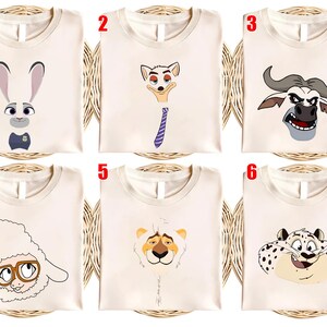 May include: Six cream-colored t-shirts, each featuring a different cartoon character from the movie "Zootopia." The designs include Judy Hopps, Nick Wilde, Chief Bogo, a sheep, a lion, and a leopard.