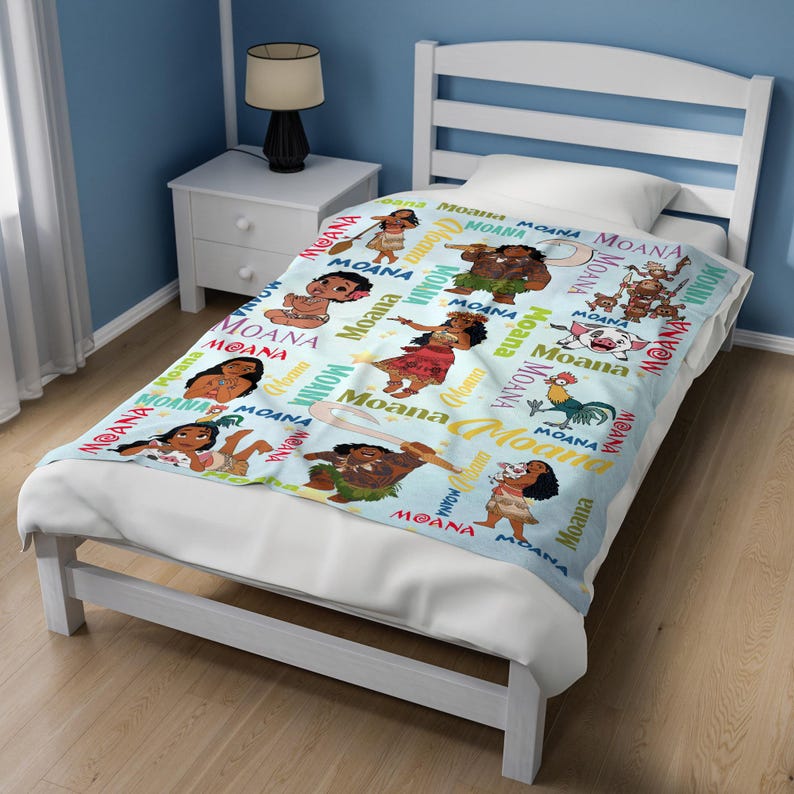 May include: A light blue throw blanket featuring a repeating pattern of characters from the movie Moana, including Moana, Maui, Pua the pig, and Heihei the rooster, interspersed with the word Moana printed in various colorful fonts and styles.