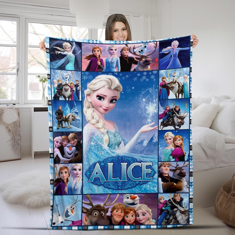 May include: A rectangular fleece blanket featuring a collage of Frozen characters including Elsa, Anna, Kristoff, Sven, and Olaf. The center displays a large image of Elsa with the name ALICE printed in bold blue letters against a snowy background.