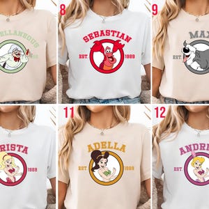 Puede incluir: Una colecci&oacute;n de camisetas con personajes de dibujos animados. Las camisetas son de varios colores, incluyendo blanco y beige. Cada camiseta tiene un gr&aacute;fico circular con la imagen y el nombre de un personaje, junto con el a&ntilde;o "1989".