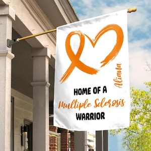 May include: White house flag with an orange heart-shaped ribbon design. The flag reads "HOME OF A Multiple Sclerosis WARRIOR" with the name "Aliana" in orange script. The flag is hanging on a gold pole.