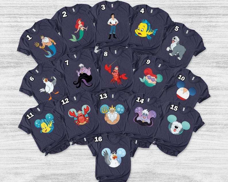 May include: A collection of navy blue t-shirts featuring various cartoon characters from a popular animated film. The designs include a mermaid, a crab, a fish, and other characters. The shirts are arranged in a circular pattern.