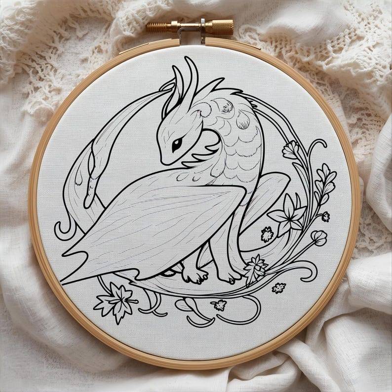 May include: A black and white embroidery hoop featuring a dragon design. The dragon is surrounded by floral elements. The embroidery is set in a wooden hoop, and the background is a white fabric.