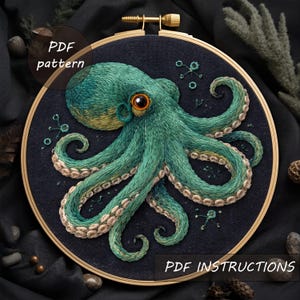 May include: An embroidered octopus design in a wooden hoop. The octopus is teal and yellow with orange eyes, stitched on a dark blue fabric. The text "PDF pattern" and "PDF instructions" are visible.
