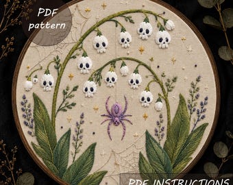 May include: An embroidery hoop containing a beige fabric with a stitched design of lily-of-the-valley flowers shaped like white skulls, a purple spider, spiderwebs, and small gold stars. The text PDF pattern and PDF INSTRUCTIONS are visible.