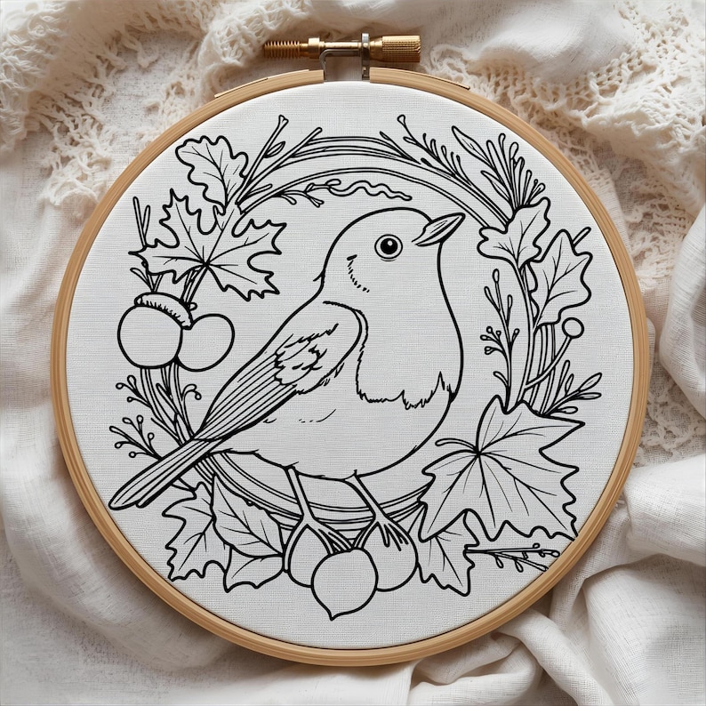 May include: A black and white embroidery hoop featuring a detailed illustration of a bird perched amidst leaves and berries. The design is set against a white fabric background, framed by a natural wood hoop.