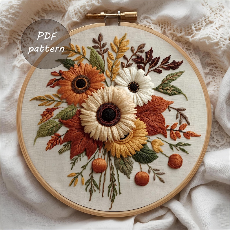 May include: Embroidered floral design featuring sunflowers, leaves, and berries in autumn colors. The embroidery is set in a wooden hoop, with the text "PDF pattern" in a circle. The color palette includes shades of orange, yellow, brown, and green.