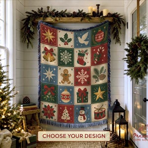 May include: A woven throw blanket featuring a grid of sixteen square panels with various Christmas icons including stars, bells, a gingerbread man, a snowman, a gift, a stocking, a candy cane, and snowflakes in red, green, blue, and cream.