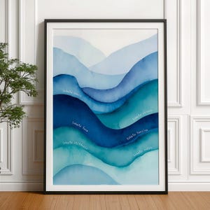 Könnte beinhalten: Gerahmter Kunstdruck mit geschichteten blauen, abstrakten Formen, die an Berge erinnern. Der Text lautet: "Inhale peace, love, stillness" und "Exhale stress, tension, noise."
