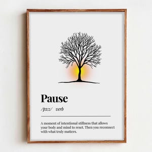 May include: A framed print featuring a black tree silhouette with a yellow and orange gradient behind it. The word "Pause" is printed in a bold font, along with a definition. The frame is a warm brown color.