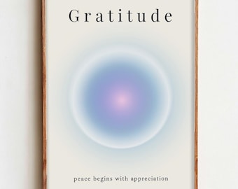 May include: A framed art print with the word "Gratitude" at the top and the phrase "peace begins with appreciation" at the bottom. The artwork features a soft, blurred blue and purple circular design on a white background.