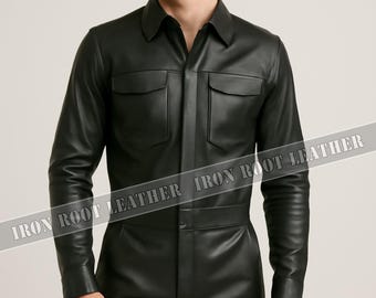 May include: Black leather jumpsuit with a collared neckline, two chest pockets, and long sleeves. The one-piece garment has a button-up front and a fitted silhouette. The model is wearing the jumpsuit.